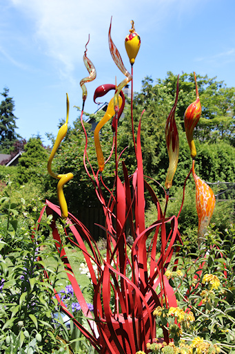 Metal and glass sculpture in flower bed&copy;Ken Woolfenden
